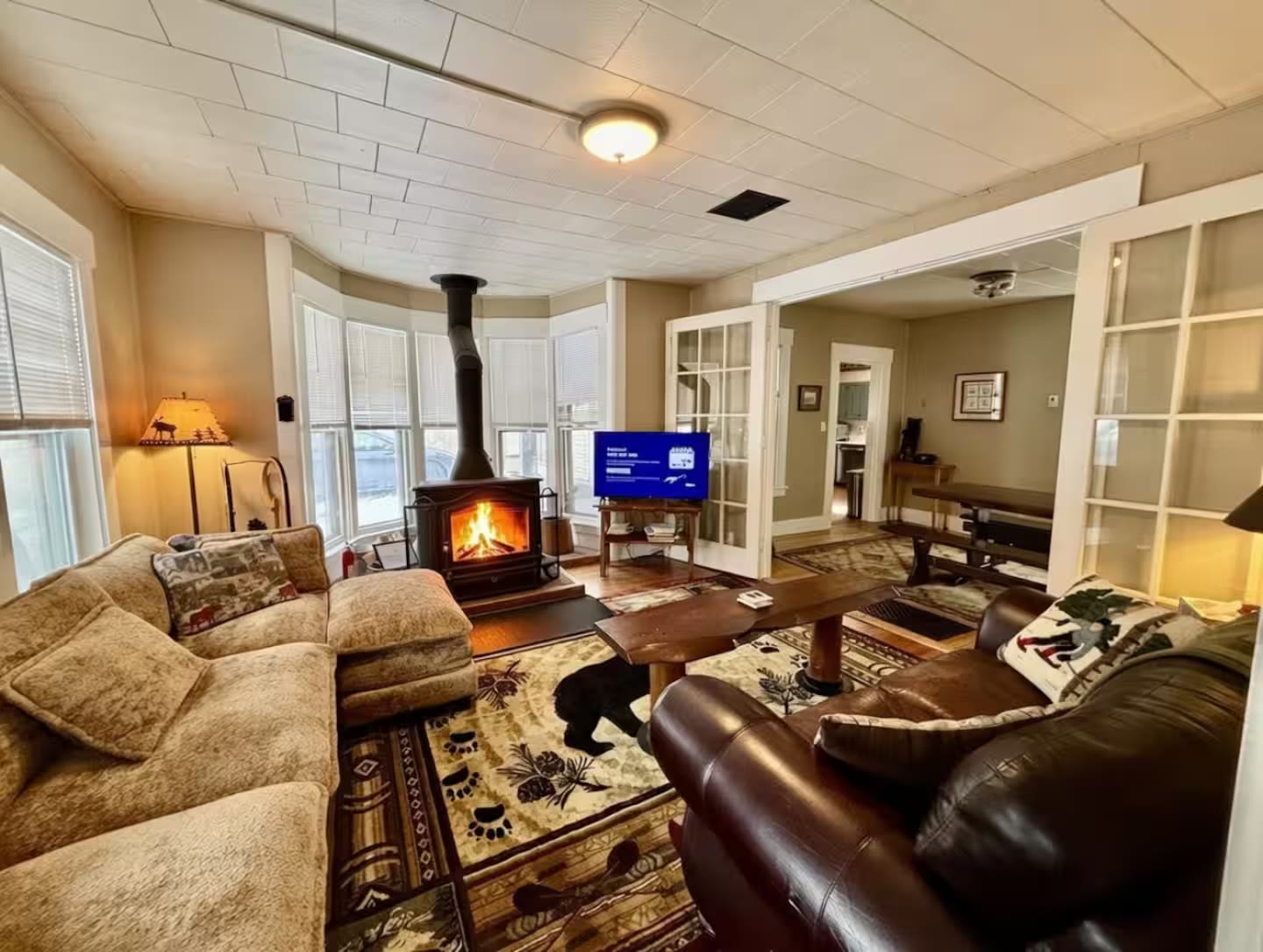 Living room with wood stove and lodge seating